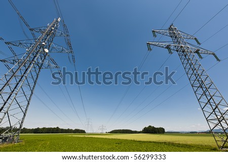 Power lines in a summer landscape with clear sky