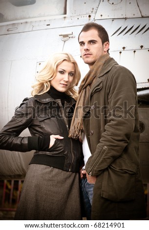 Man and Woman standing in front of an old airplane