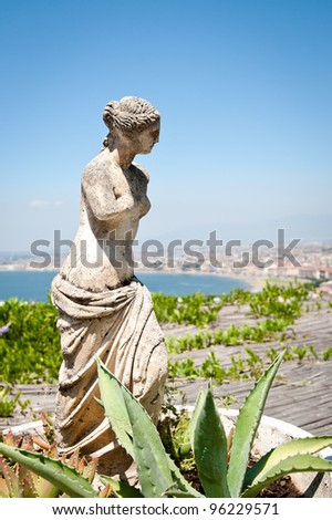 Antique sculpture in front of the bay of naples