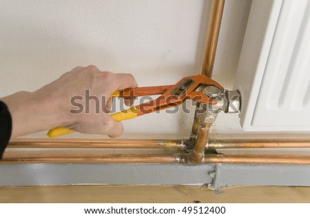 hand of plumber with pliers