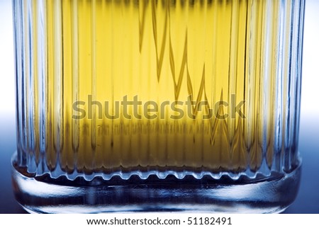 macro of a perfume bottle with orange fluid