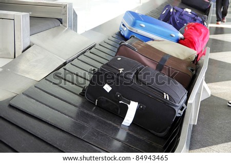 suitcases on a luggage band on the airport