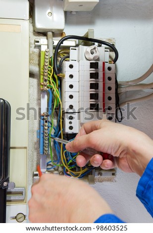 hands of an electrician measuring electrical cables