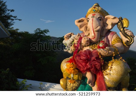 The Lord Ganesha Statue (Hindu God Ganesha) in The Thai Temple with Landscape Background and Twilight in Evening.(This picture is taken in a public area and be permitted to take picture for sale)