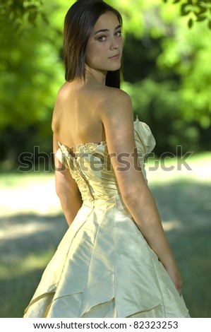 Summer wedding with young bride in park