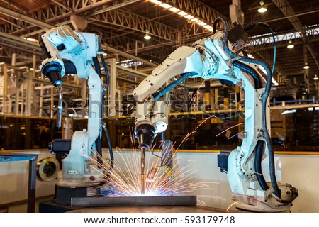 Industrial robots are welding automotive part in car factory
