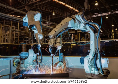 Industrial robots are welding assembly automotive part in car factory
