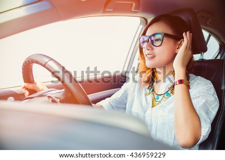 asian woman driving a car