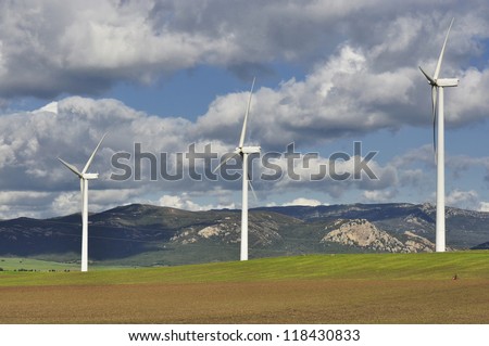 Collection of wind turbines producing clean alternative energy in remote location in Spain