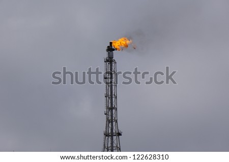 Tower fire, industrial tubes - Flame torch, environment pollution.