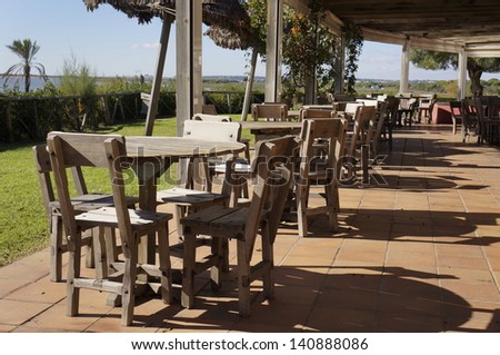Outdoor beach restaurant, coffee tables at the sea shore, Spain
