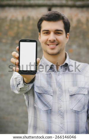 Young man showing a smart phone screen