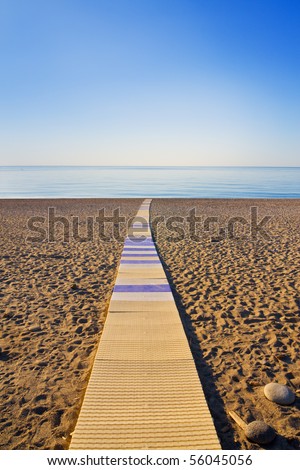 Boardwalk cross the beach and lead to the sea
