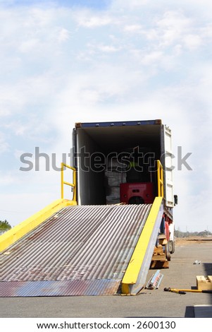 Semi truck with forklift driver in back of container