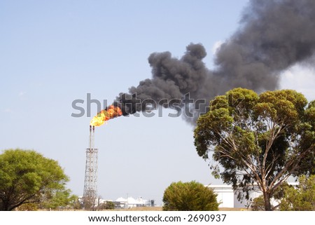 Refinery fire stack with lots of black smoke
