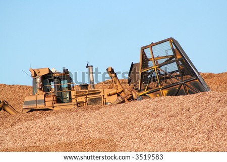 Earthmover driving in wood chips