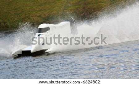 White F1 speed boat racing through the water