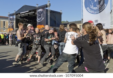 HELSINKI, FINLAND - JUNE 29: Unidentified Fans moshing at gig of american heavy metal band Trivium June 29, 2012 at 15th annual Tuska Open Air Metal Festival in Suvilahti, in Helsinki, Finland.