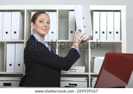 smart secretary puts a folder to the cabinet
