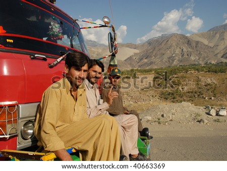 NORTHERN AREAS, PAKISTAN - OCTOBER 26: Three men hitch a lift along the Karakoram Highway in the absence of public transport on October 26, 2008 in Northern Areas, Pakistan.