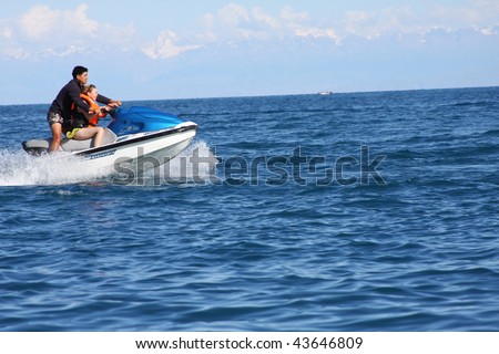 DONEGAL, IRELAND - JULY 3: A couple rides a jet ski July 3, 2009 in Donegal, Ireland. County council bans use of jet skis on its beaches after series of accidents and complaints about noise pollution.