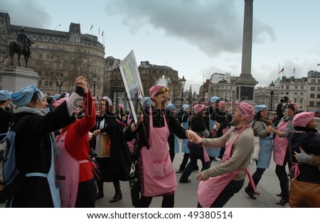 TRAFALGAR SQUARE, LONDON - FEBRUARY 25: Fair trade campaigners dressed as tea ladies dance for charity on February 25, 2010 in Trafalgar Square, London