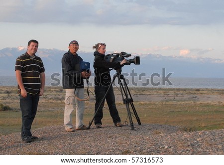 ISSYK KUL, KYRGYZSTAN - SEPTEMBER 3: BBC crew film news report for World Service on September 3, 2010 in Issyk Kul, 2009. They are reporting on the country\'s emerging tourism industry.