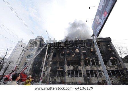 BISKEK, KYRGYZSTAN - APRIL 7: Fire crews dowse burning Ministry of Justice building on April 7, 2010 in Bishkek, Kyrgyzstan. The building was set alight during Kyrgyzstan\'s revolution.
