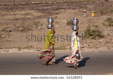 RAJASTHAN, INDIA - FEB. 21: Indian women carry water jugs on their head, Feb. 21, 2010 in Rajasthan, India.