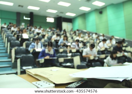Abstract blur background of student during study or quiz, test and exams from teacher or in large lecture room / University classroom.