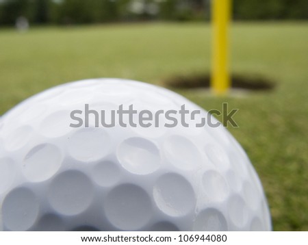 Golf ball traveling towards hole
