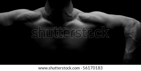 Muscular male raising arms and shoulders