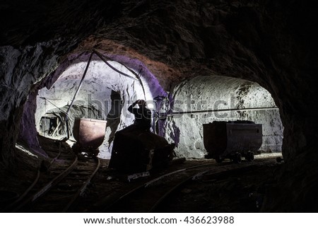 equipment, underground, miner, flashlight, cart, miner with a head lam siting on a cart