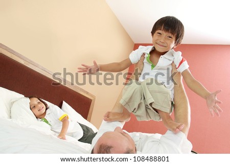 Father and son in bed having fun, happy time