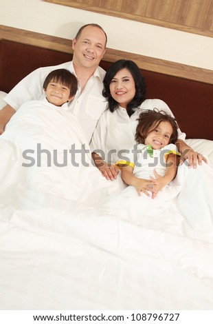 happy Family lying down in the bedroom