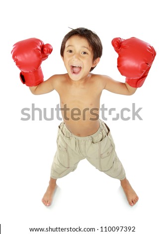 portrait of happy young kid with boxing glove in winning pose