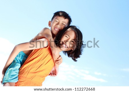 Portrait of a happy kids having fun doing piggyback ride
