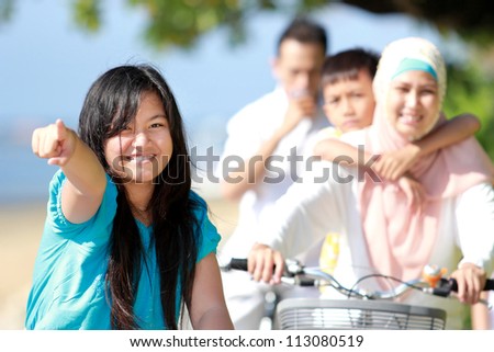 young girl with her family riding bikes outdoor