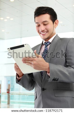 portrait of successful young business man with tablet in the office