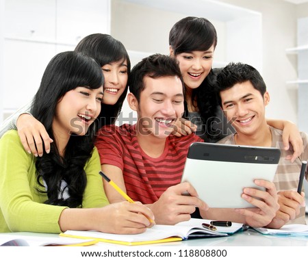 Group of students looking at tablet pc together