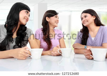 group of women friends chatting over coffee at home