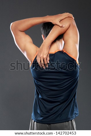 Young male model stretching shoot from behind