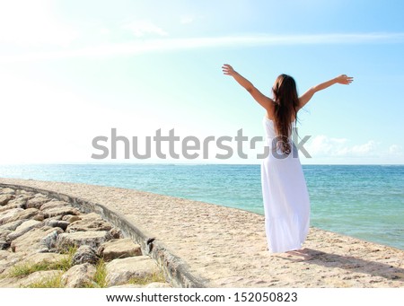 Woman Relaxing At The Beach With Arms Open Enjoying Her Freedom Wear Long White Dress