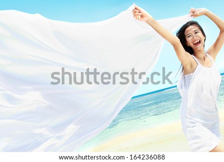 Travel And Vacation. Freedom Concept. Beautiful Girl With White Scarf On The Beach Enjoying Summer.