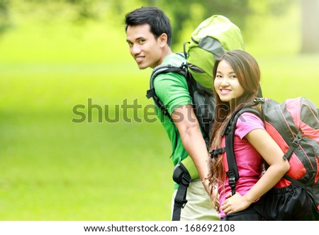 camping concept. young man and woman with backpack camping together in the park