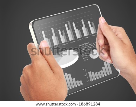image of hands holding futuristic transparent tablet pc. business chart financial concept
