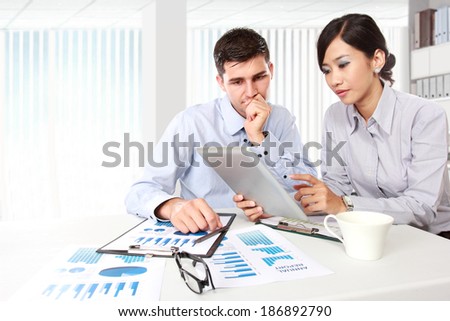 Image of two young business people at the meeting in the office