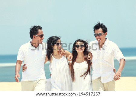 Portrait of best friend in white having fun laughing together at the beach