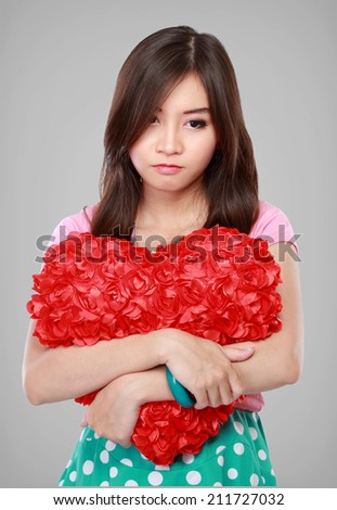 Sad asian young woman with a broken heart