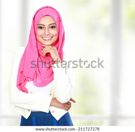 portrait of young attractive woman wearing scarf smiling to the camera
